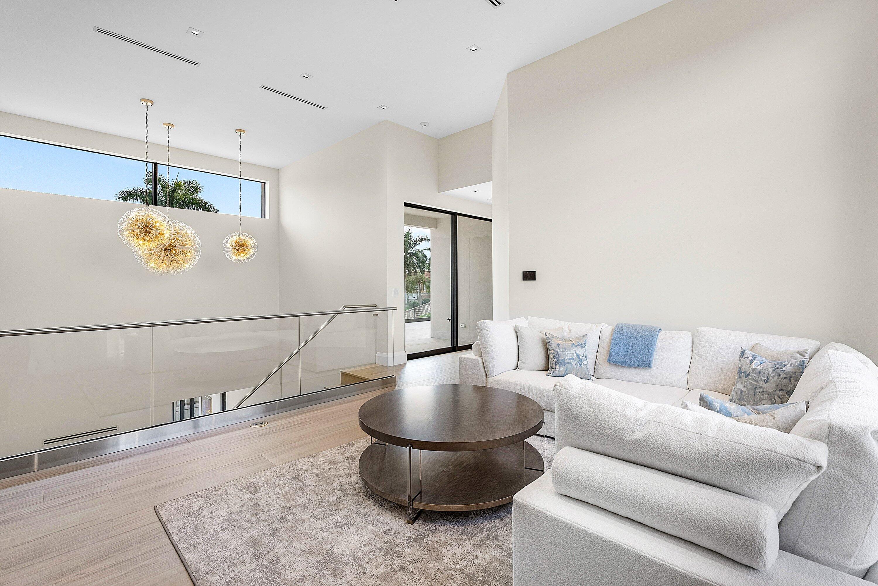 17615 Foxborough Lane Boca Raton, FL 33496 - Photo 39 of 120 a living room with a couch and a chandelier