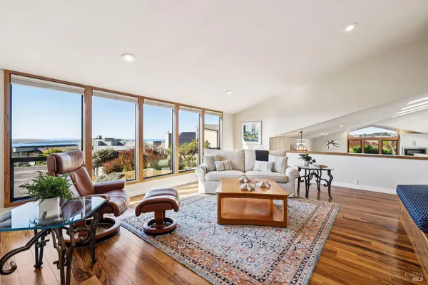 a living room with furniture a rug and a table