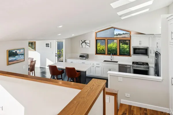 a kitchen with a stove a sink and a microwave