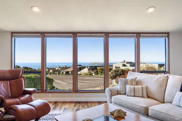 a living room with furniture and a floor to ceiling window