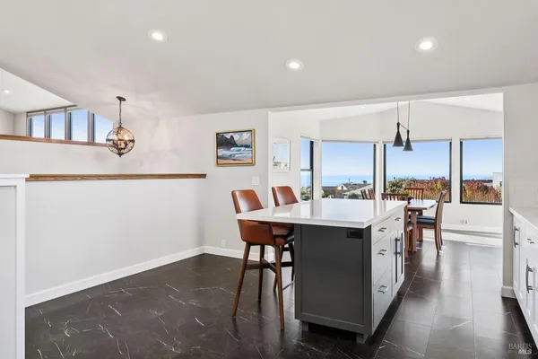 a dining room with furniture and floor to ceiling window