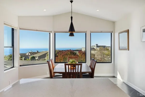 a view of a city from a dining room with furniture window and outside view