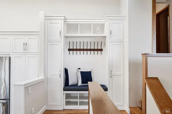 a bedroom with a bed and painting on the wall