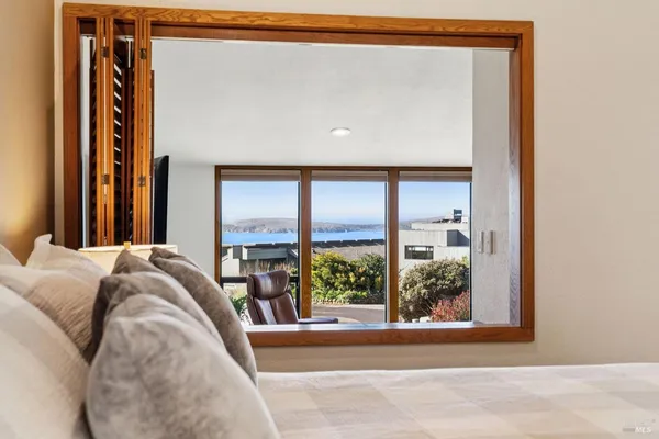 a bedroom with a large bed and a large window