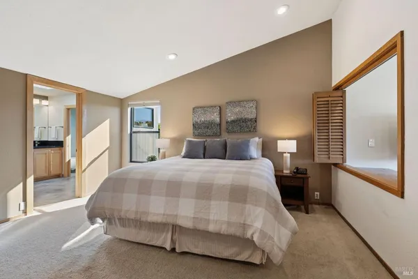 a large bathroom with a glass shower door and a sink