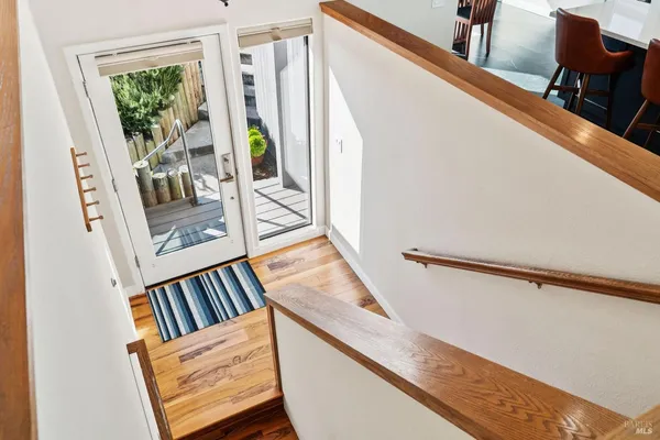 a view of entryway and hall with wooden floor