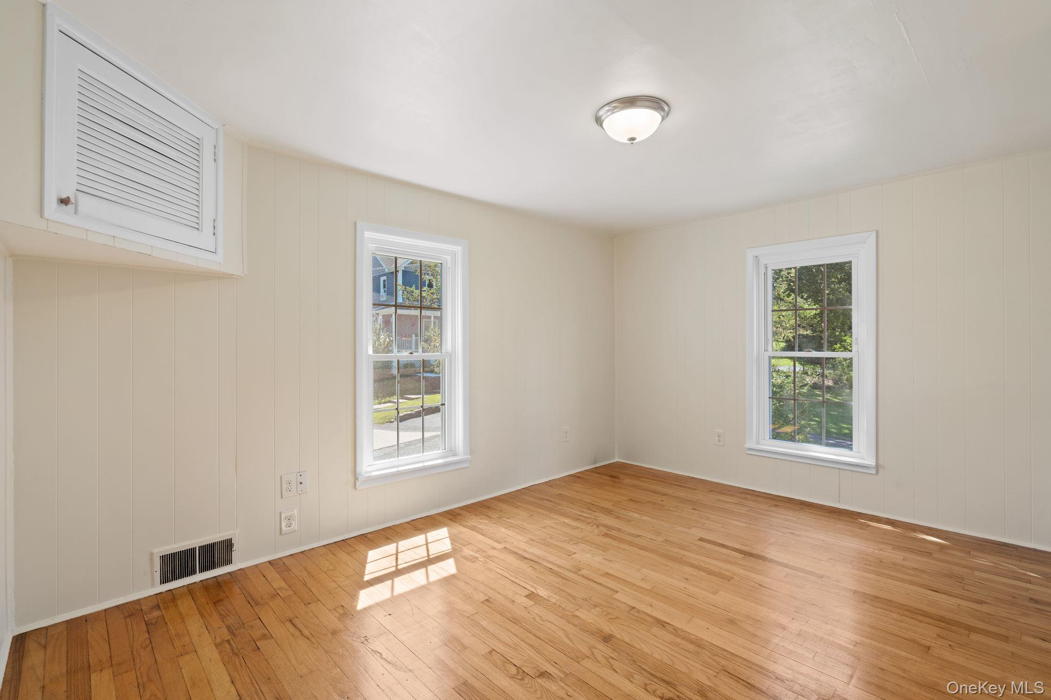 1 2nd Street Walden, NY 12586 - Photo 15 of 42 Spare room featuring light wood finished floors, healthy amount of natural light, and wood walls