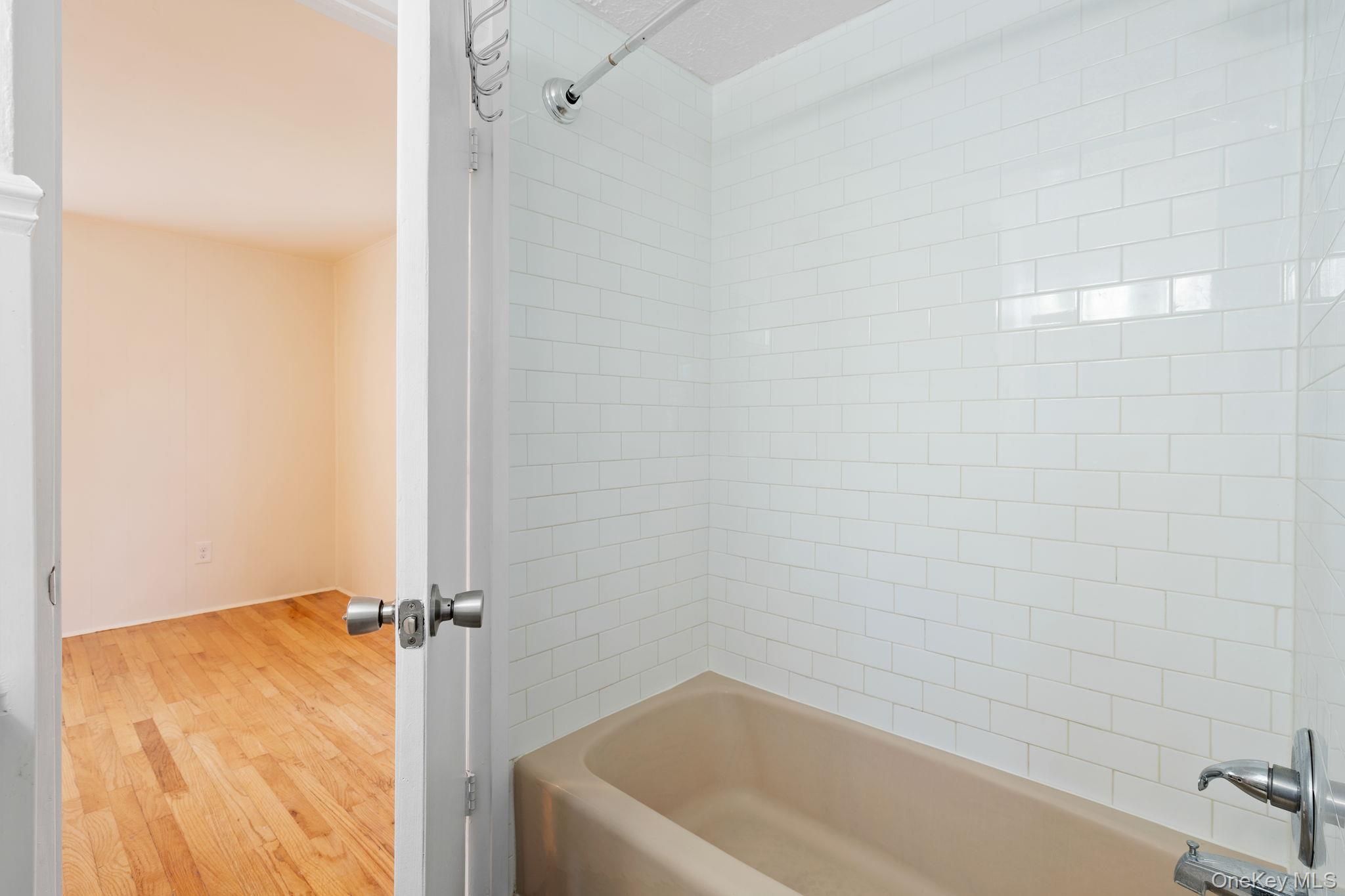 1 2nd Street Walden, NY 12586 - Photo 20 of 42 Bathroom featuring bathtub / shower combination and light wood finished floors