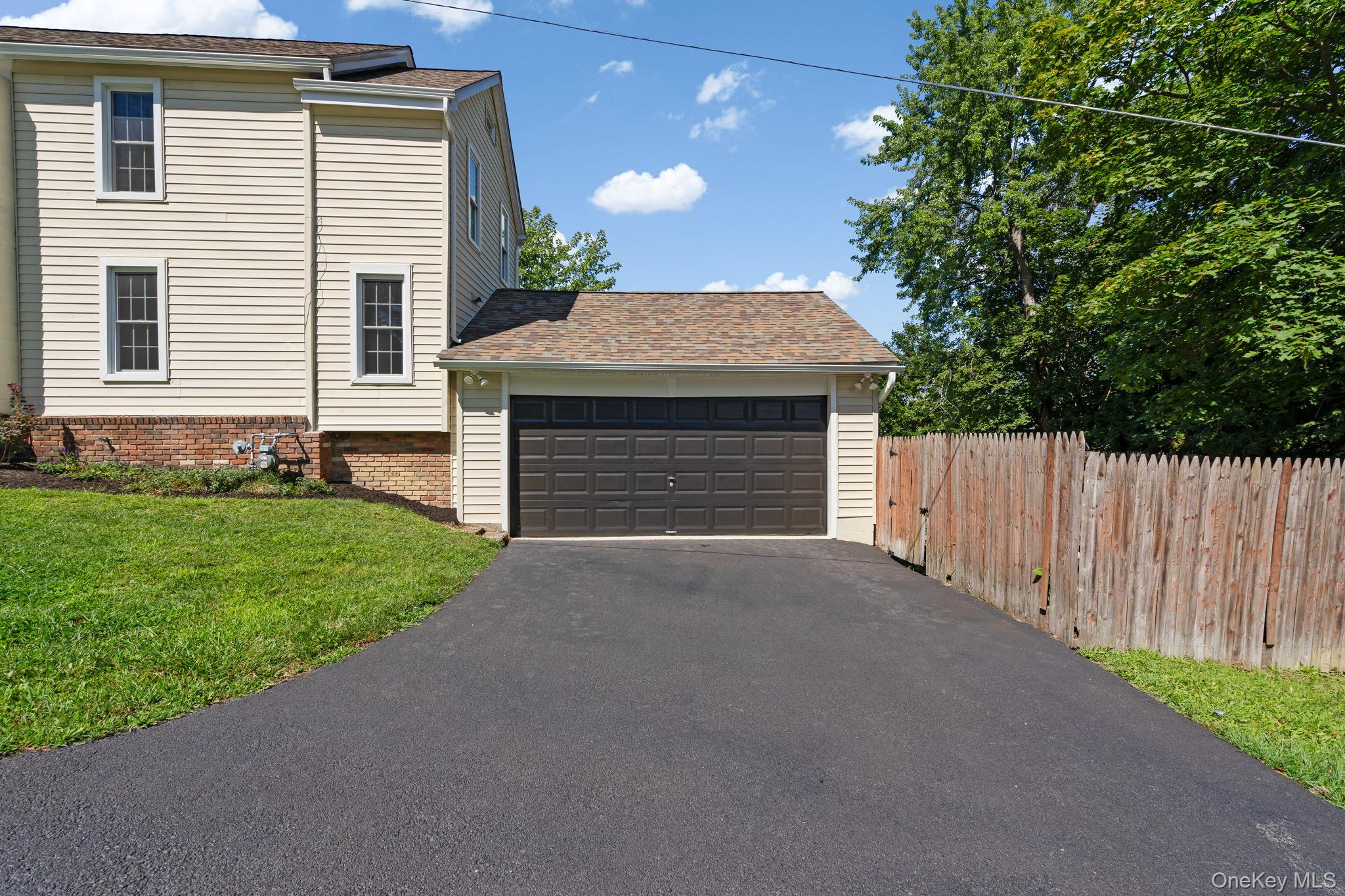 1 2nd Street Walden, NY 12586 - Photo 32 of 42 View of property exterior with a garage, roof with shingles, and brick siding