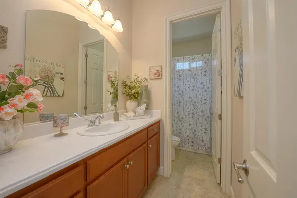 a bathroom with a sink a vanity and a mirror