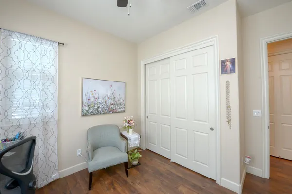 a hallway with a couch and a workspace