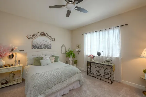a bedroom with a bed and window