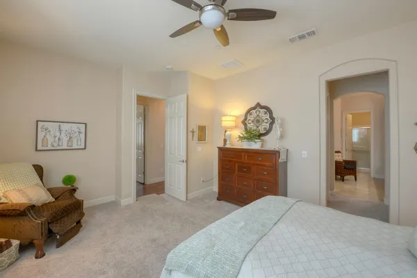 a bedroom with a bed and a chandelier