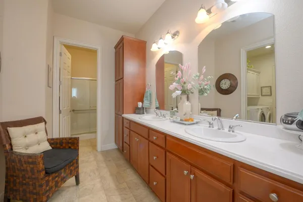 a spacious bathroom with a double vanity sink and a mirror
