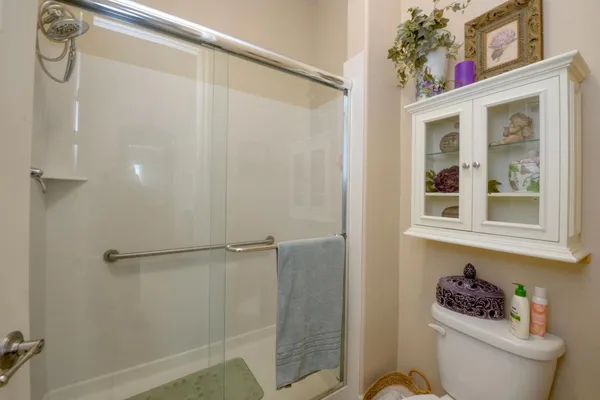 a bathroom with a toilet and a shower