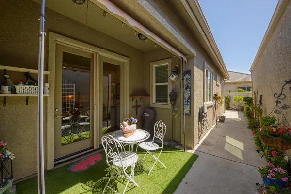a view of a porch with chairs and potted plants