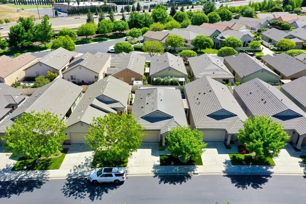 an aerial view of a house with a yard and garden
