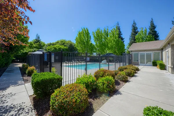 a view of a patio with table and chairs a barbeque with wooden fence