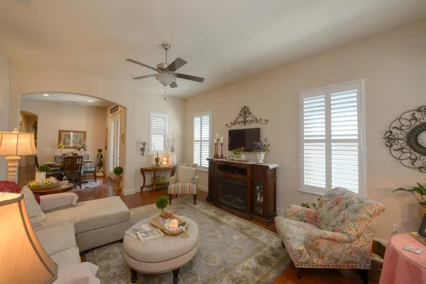 a living room with furniture a window and a flat screen tv