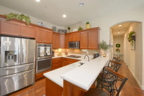 a kitchen with stainless steel appliances a refrigerator sink and stove
