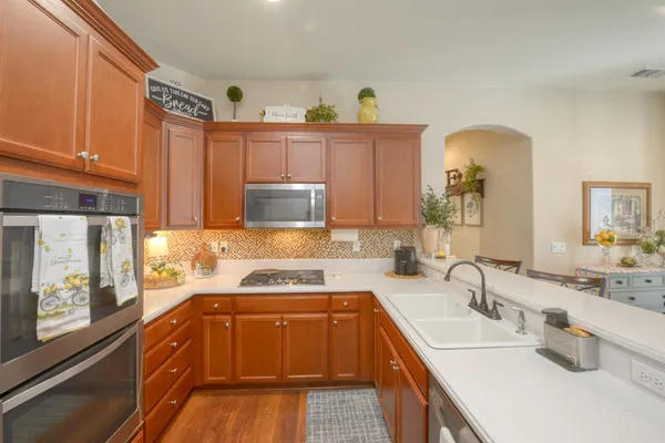 a kitchen with a sink a stove and cabinets
