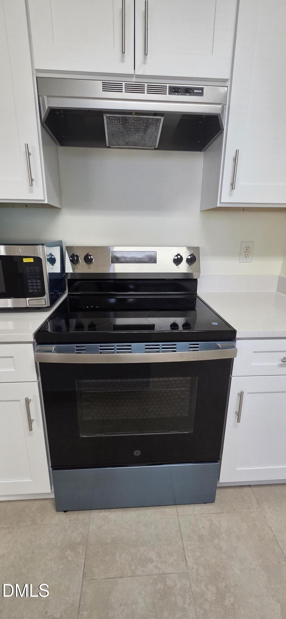 2349 Sapphire Valley Drive Raleigh, NC 27604 - Photo 16 of 46 a stove top oven sitting inside of a kitchen