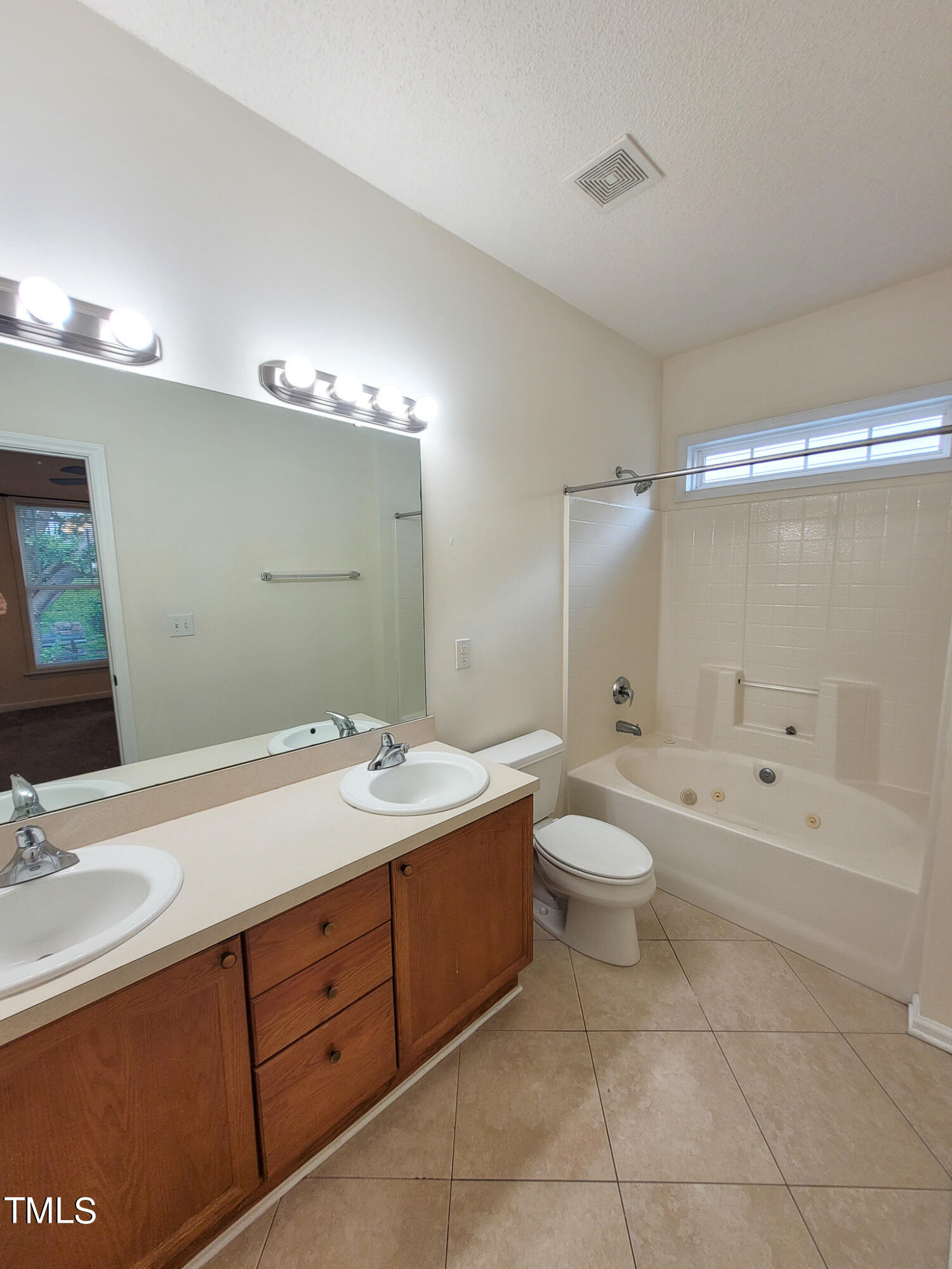 2349 Sapphire Valley Drive Raleigh, NC 27604 - Photo 29 of 46 a spacious bathroom with a double vanity sink toilet mirror and bathtub