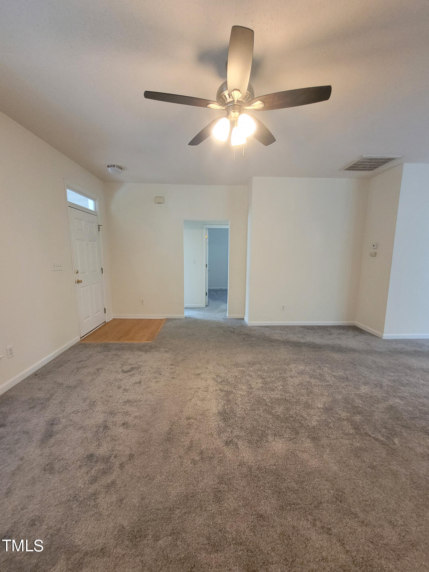 2349 Sapphire Valley Drive Raleigh, NC 27604 - Photo 9 of 46 en empty room with ceiling fan and window