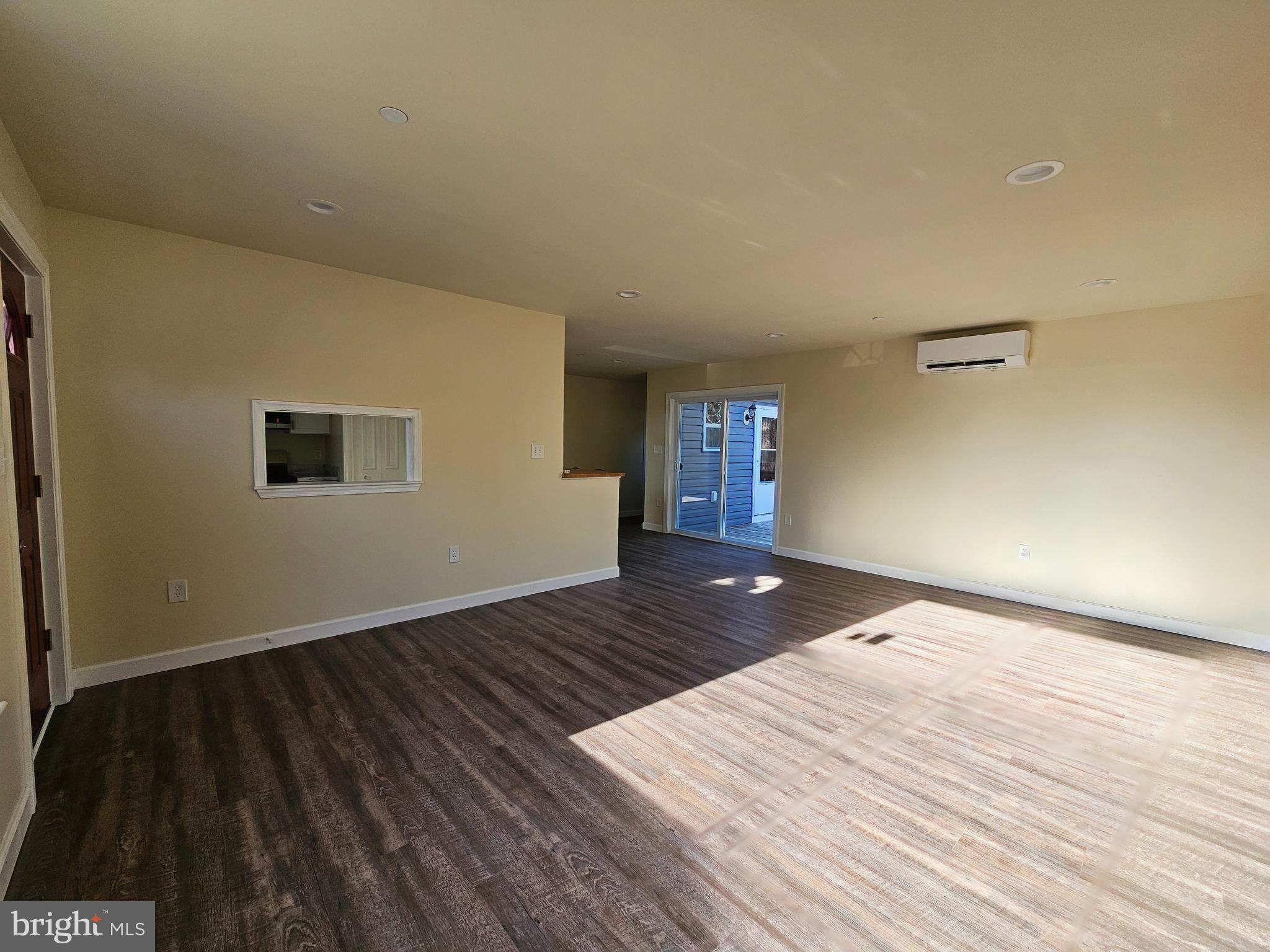 26404 Franklin Road Crisfield, MD 21817 - Photo 4 of 31 a view of an empty room with wooden floor and a window