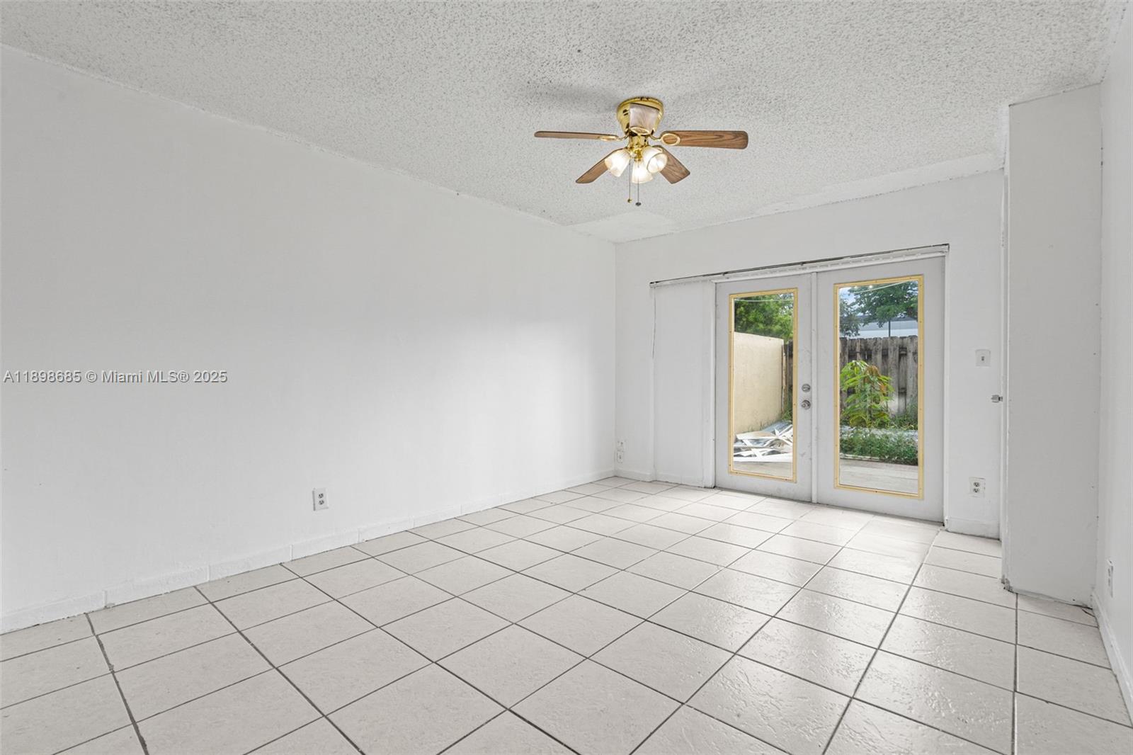 941 Southwest 20th Court Delray Beach, FL 33445 - Photo 13 of 46 a view of an empty room with a chandelier fan