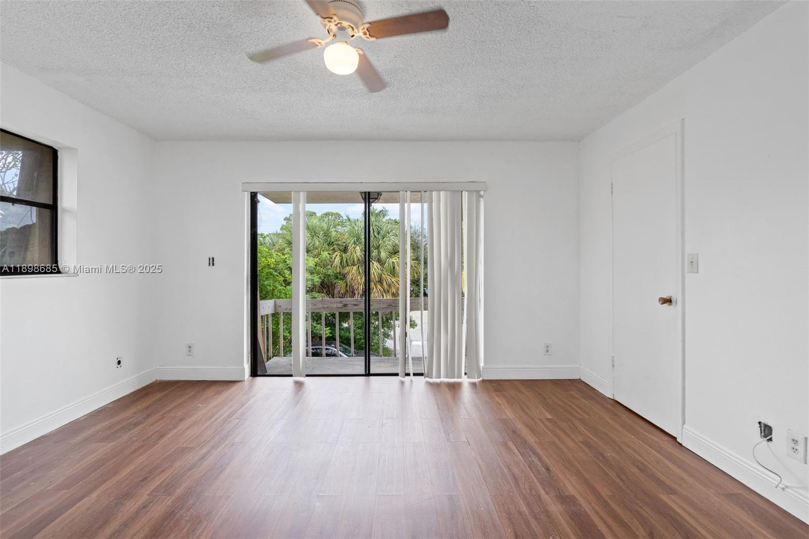 941 Southwest 20th Court Delray Beach, FL 33445 - Photo 17 of 46 wooden floor in an empty room with a window