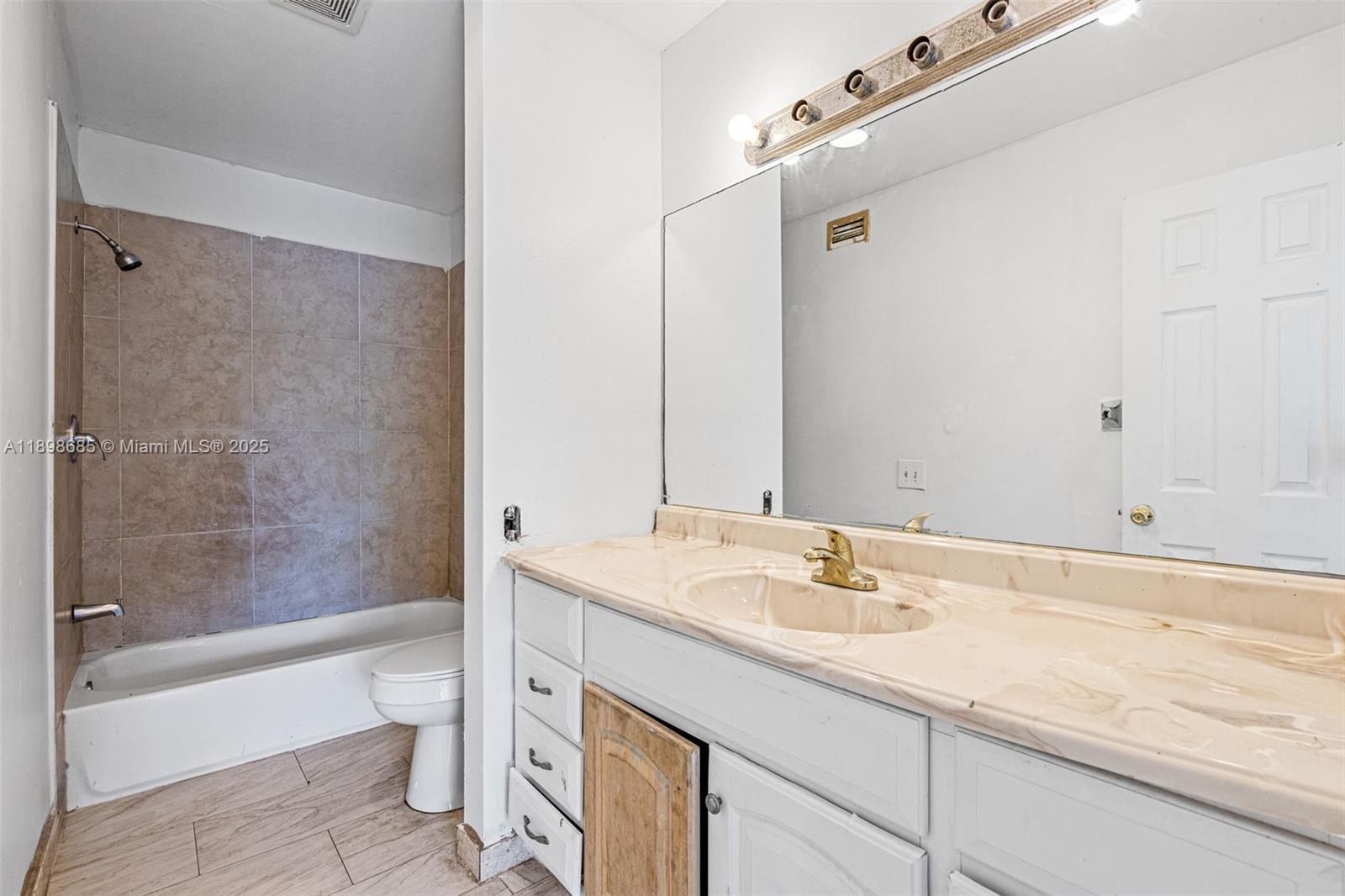 941 Southwest 20th Court Delray Beach, FL 33445 - Photo 20 of 46 a bathroom with a granite countertop sink a toilet and shower
