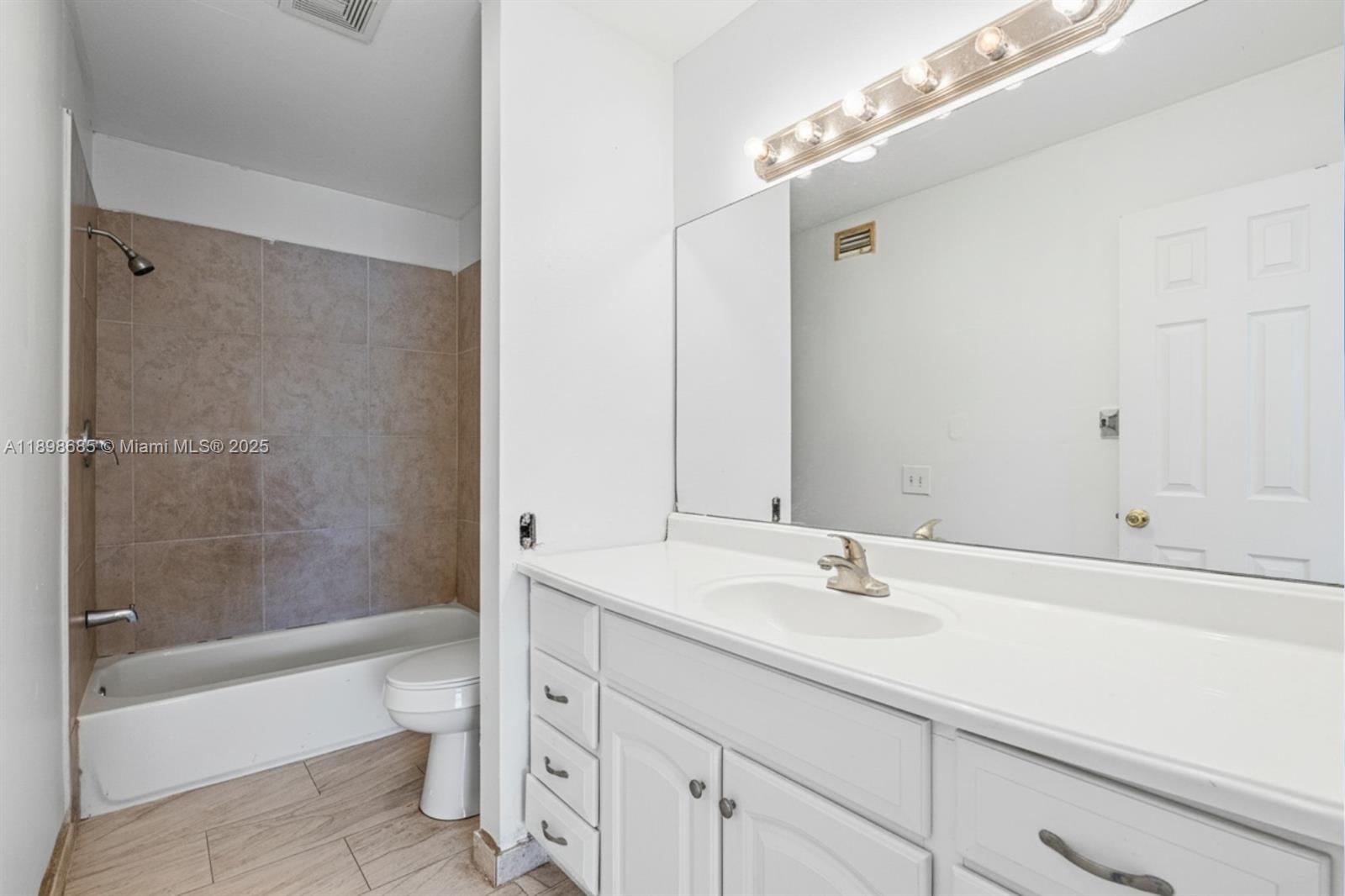 941 Southwest 20th Court Delray Beach, FL 33445 - Photo 21 of 46 a bathroom with a sink a toilet and shower