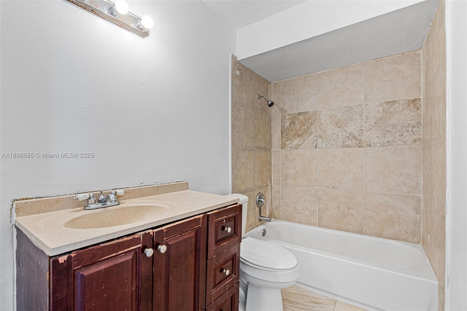 941 Southwest 20th Court Delray Beach, FL 33445 - Photo 26 of 46 a bathroom with a sink a toilet and shower