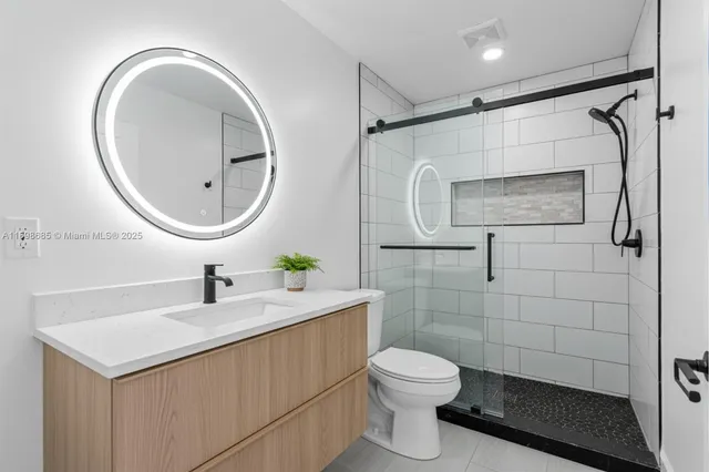 a bathroom with a sink a toilet and a mirror