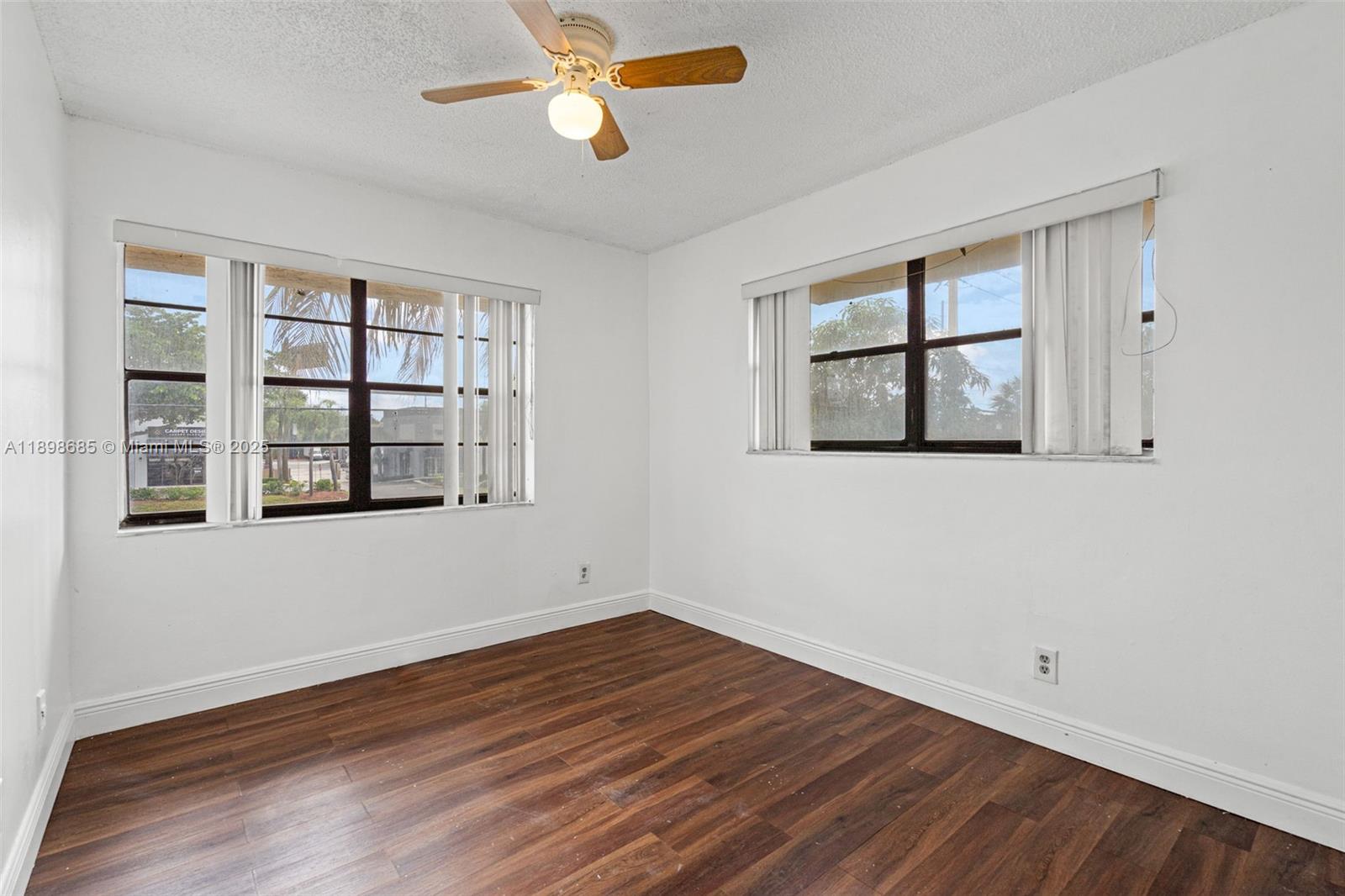 941 Southwest 20th Court Delray Beach, FL 33445 - Photo 28 of 46 a view of empty room with wooden floor and fan
