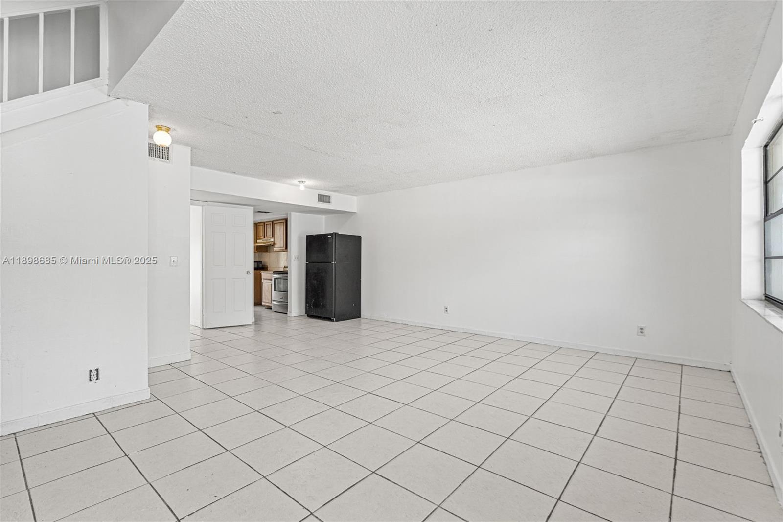 941 Southwest 20th Court Delray Beach, FL 33445 - Photo 3 of 46 a view of an empty room and window
