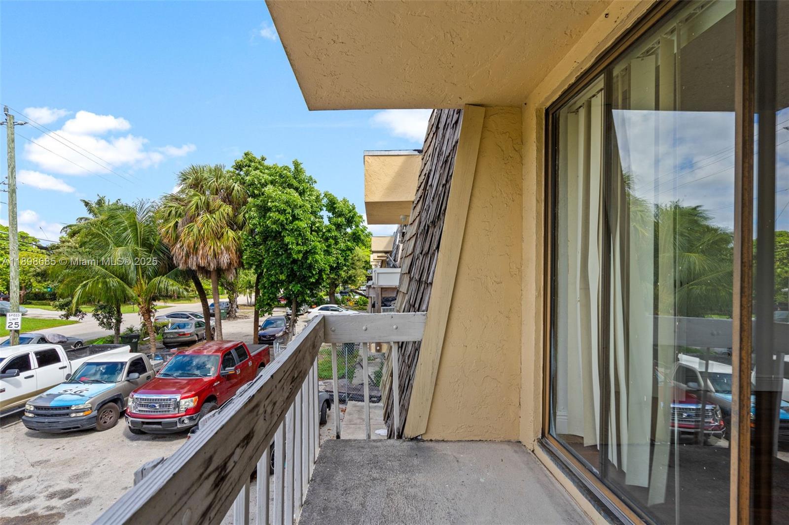 941 Southwest 20th Court Delray Beach, FL 33445 - Photo 32 of 46 a balcony view with couple of cars parked on road