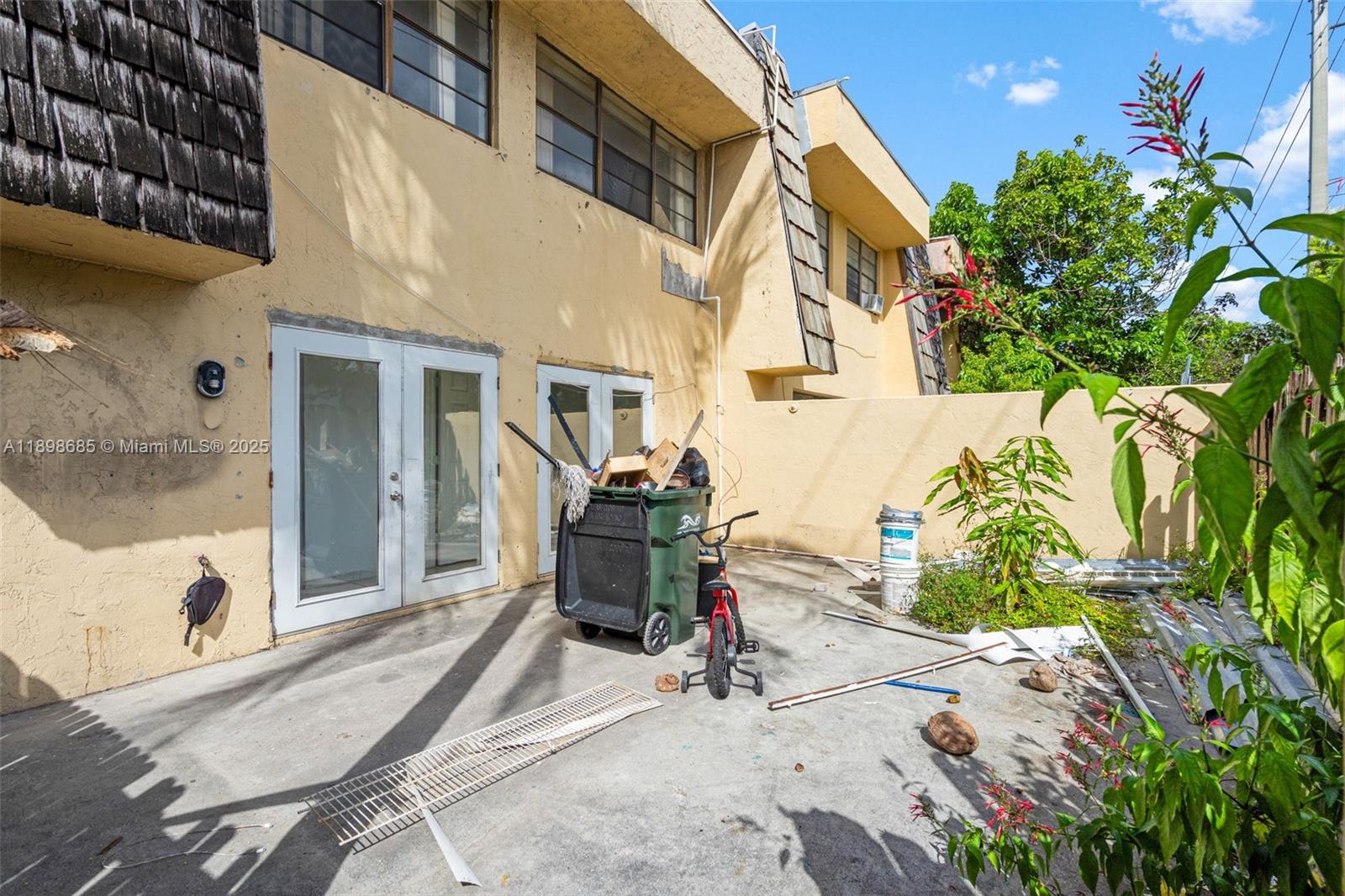 941 Southwest 20th Court Delray Beach, FL 33445 - Photo 36 of 46 a view of a patio with table and chairs and potted plants