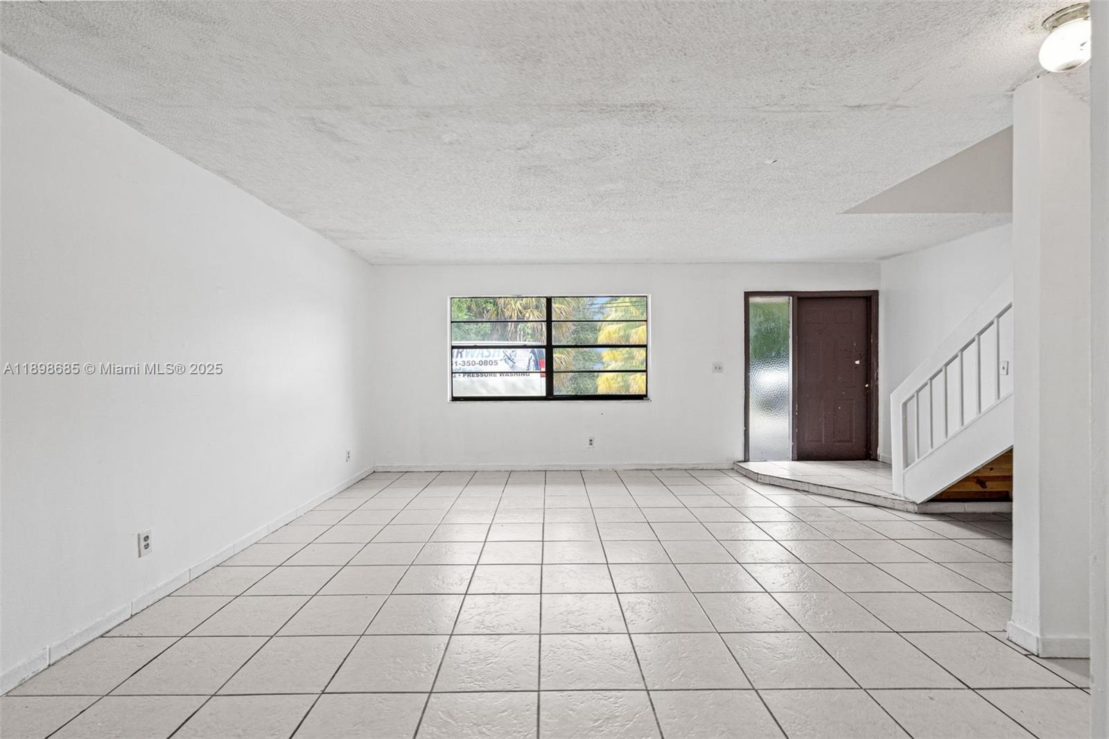 941 Southwest 20th Court Delray Beach, FL 33445 - Photo 6 of 46 a view of an empty room with a window