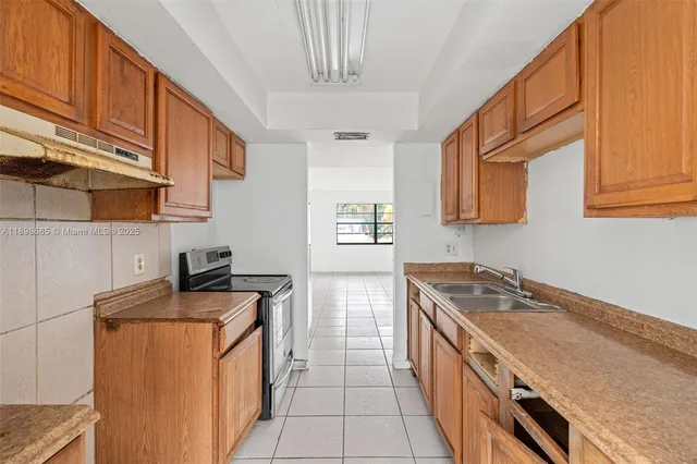 a kitchen with stainless steel appliances granite countertop a stove a sink dishwasher and a refrigerator