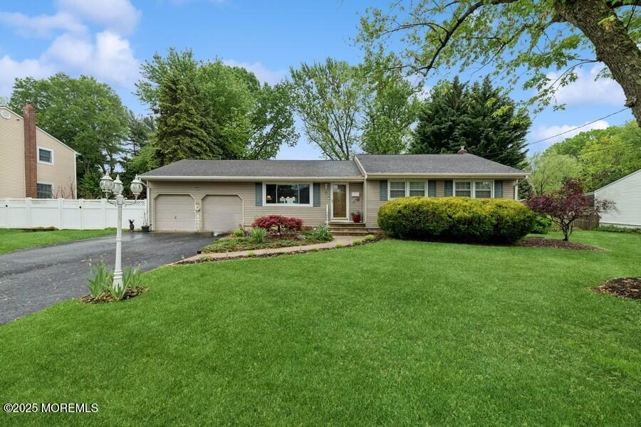 10 Crescent Road Holmdel, NJ 07733 - Photo 1 of 27 a front view of a house with a garden