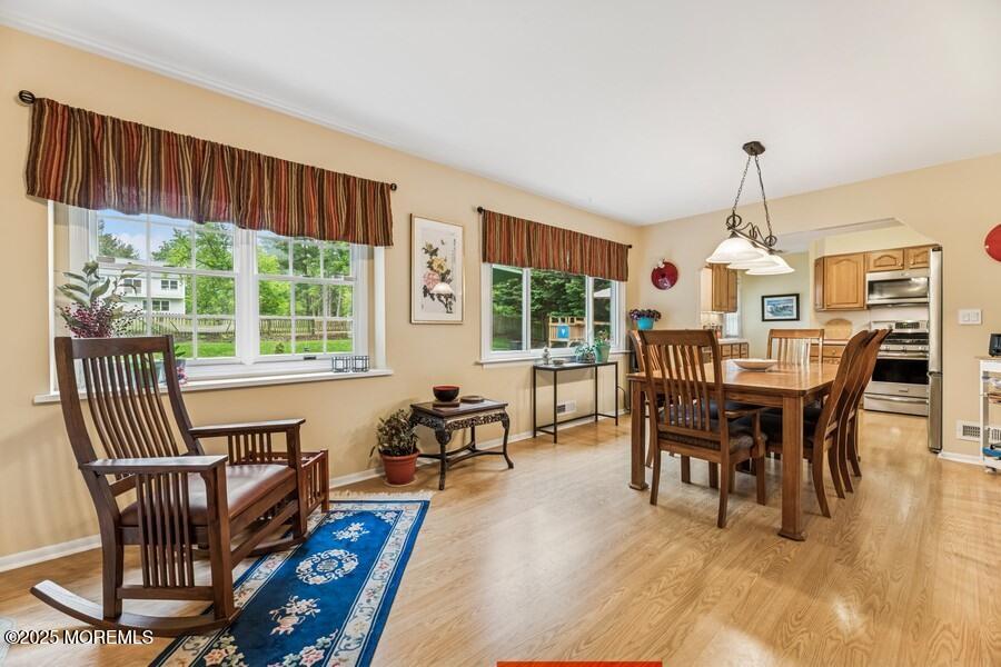 10 Crescent Road Holmdel, NJ 07733 - Photo 7 of 27 a dining room with furniture a chandelier and wooden floor