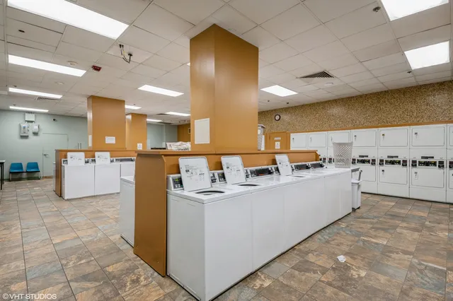 a large white kitchen with cabinets and a couch