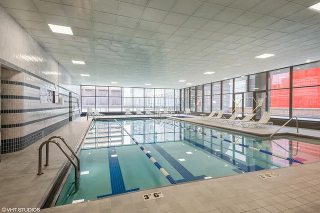 a view of a kitchen with kitchen island a sink wooden floor and a counter top space