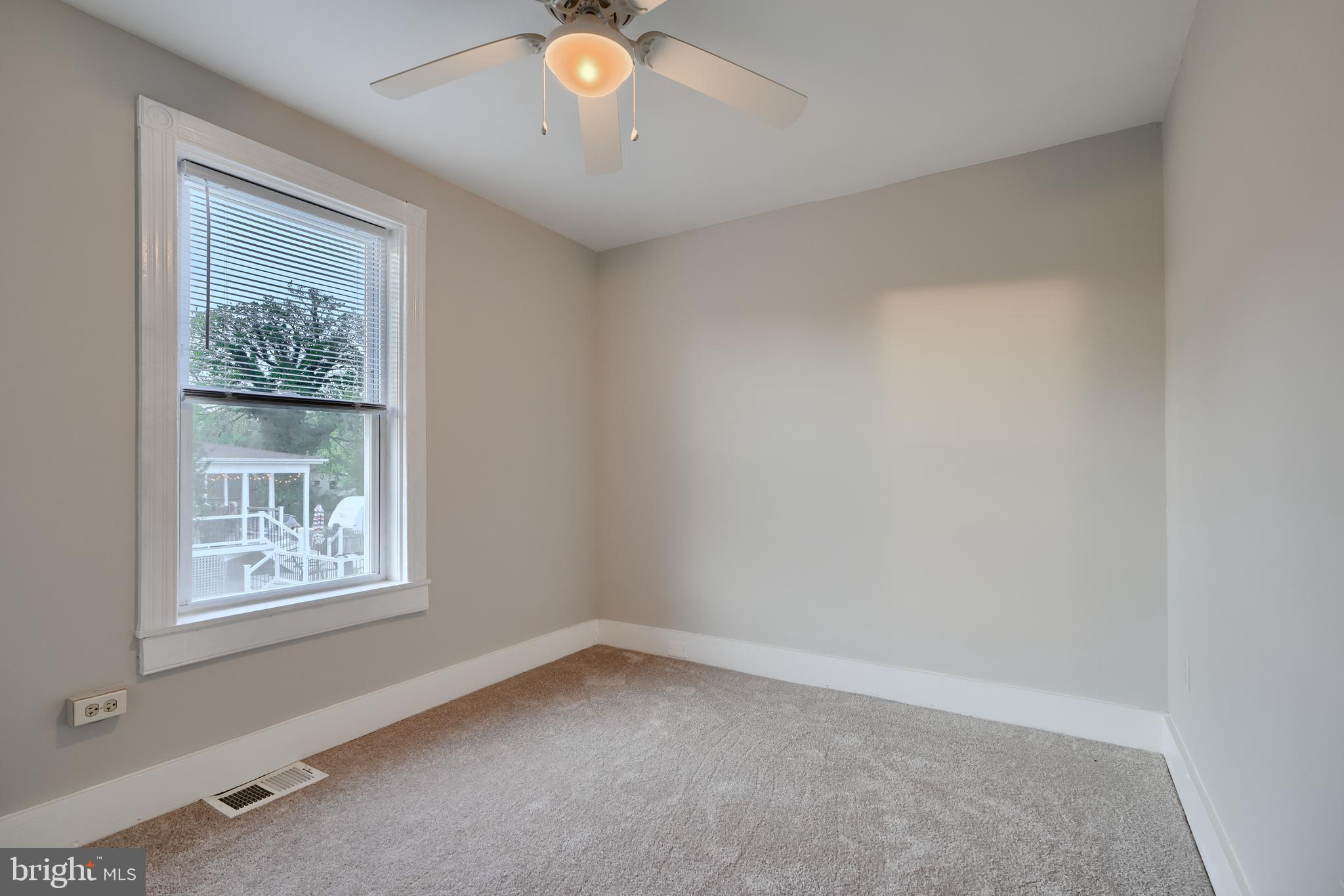 1817 Summit Avenue Baltimore, MD 21227 - Photo 11 of 28 an empty room with windows