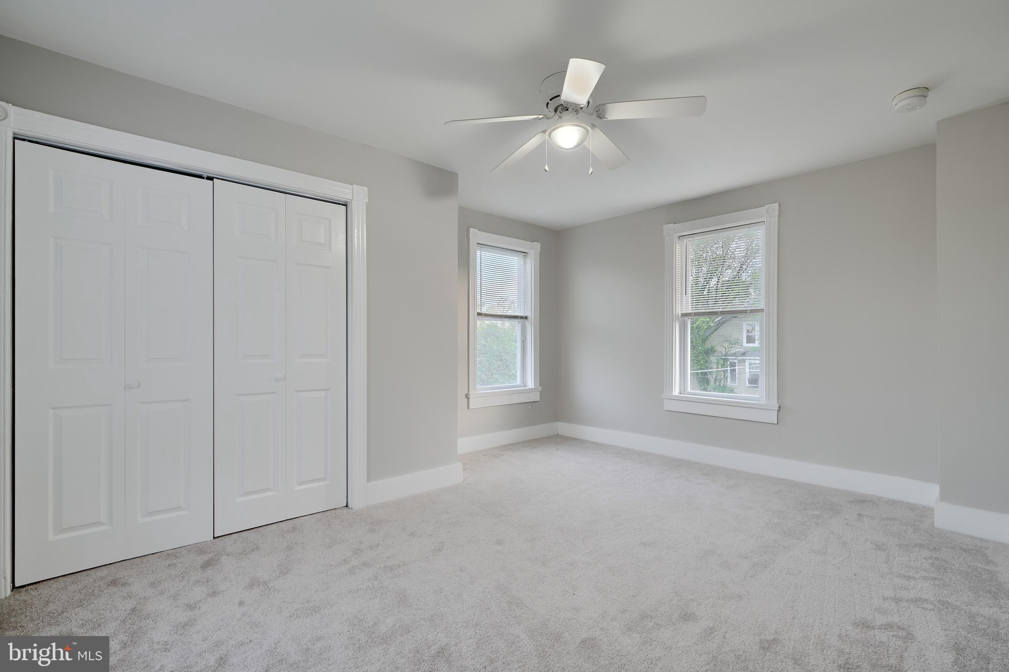 1817 Summit Avenue Baltimore, MD 21227 - Photo 13 of 28 a view of an empty room with windows