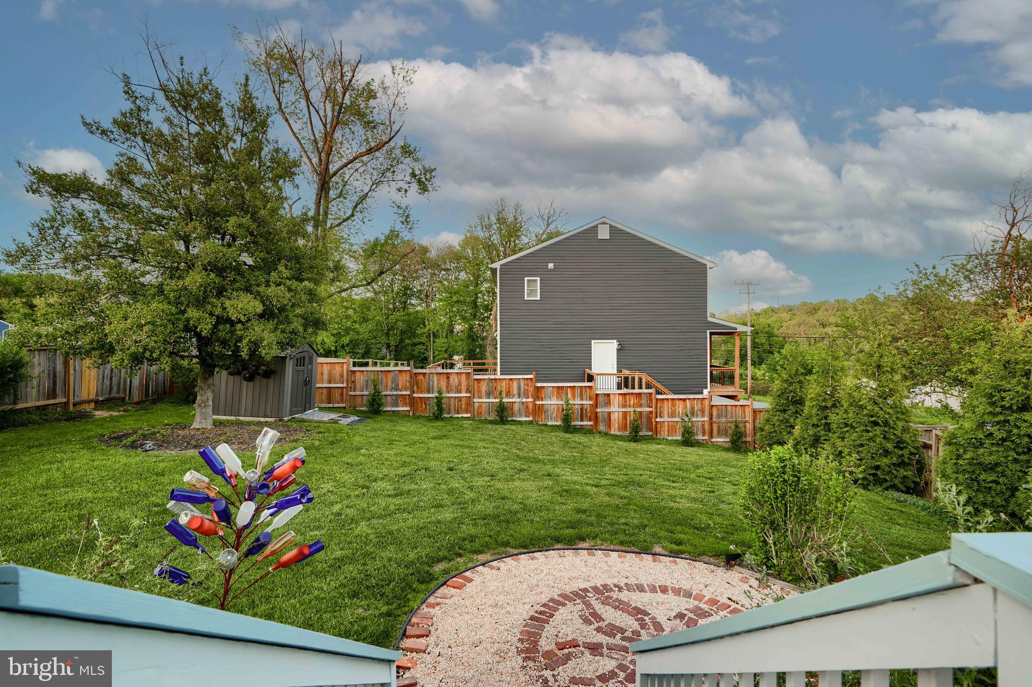 1817 Summit Avenue Baltimore, MD 21227 - Photo 22 of 28 a view of a backyard with couches plants and large tree