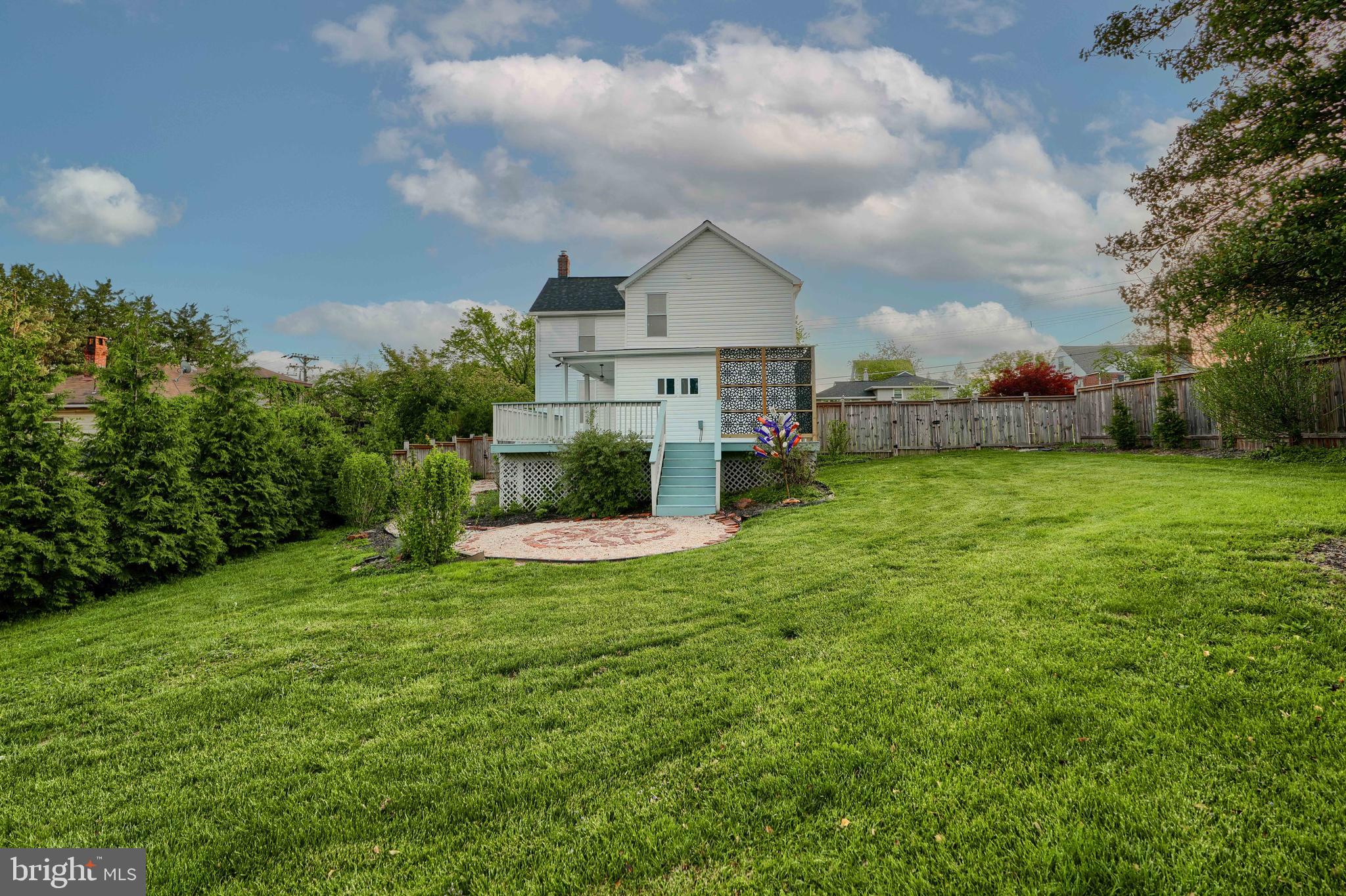 1817 Summit Avenue Baltimore, MD 21227 - Photo 24 of 28 a view of a house with a big yard and a large tree