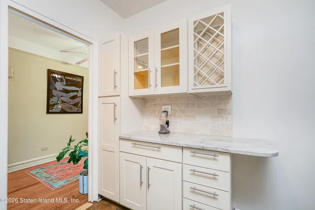 a kitchen with stainless steel appliances cabinets and a potted plant